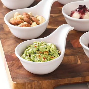 White ceramic bowls with various contents on a wooden surface
