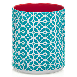 Cylindrical utensil holder with blue floral pattern and red interior on a white background