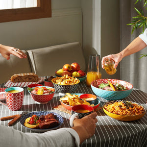 People enjoying a meal together at a table with various dishes and drinks.