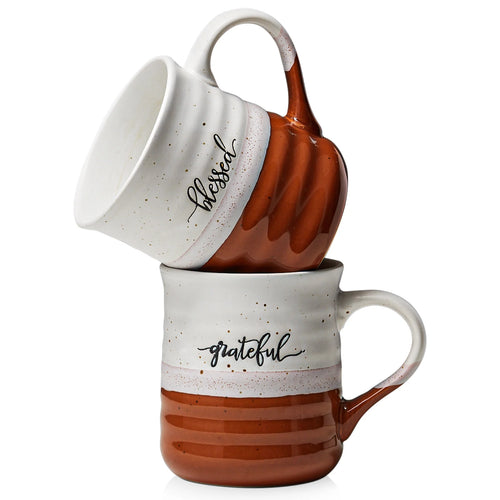 Two ceramic mugs with 'blessed' and 'grateful' text on a white background