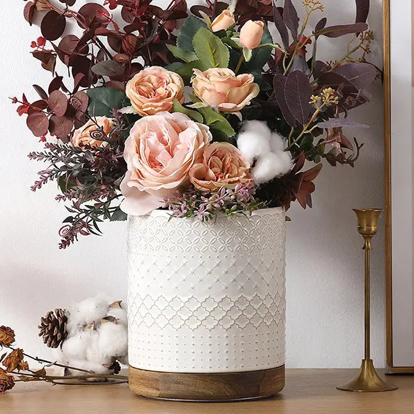 White stoneware utensil holder with wooden base and geometric pattern, on a white background