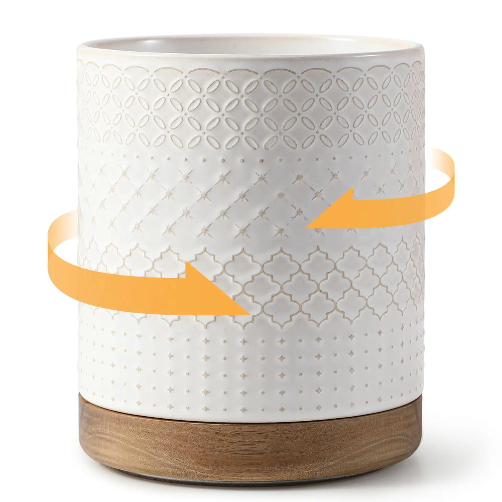 White stoneware utensil holder with wooden base and geometric pattern, on a white background