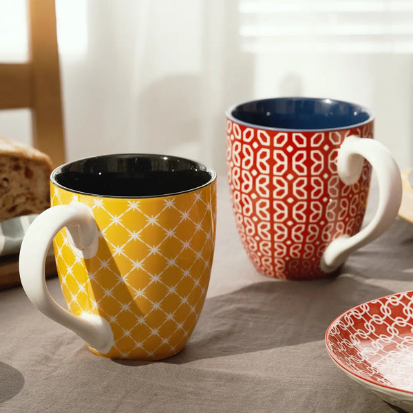 Two colorful coffee mugs on a table 